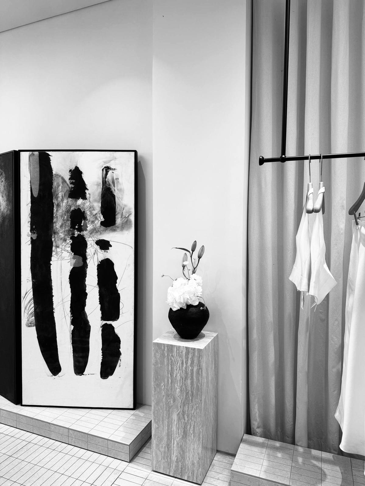 Inside Olga's studio — artwork, fresh flowers and a rail of white garments